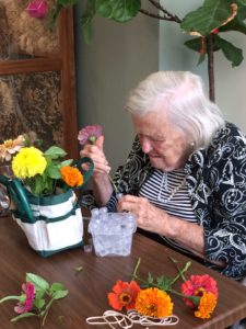 A resident at Abe's Garden works on a flower arrangement.